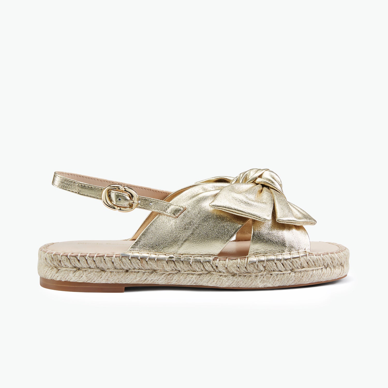 Gold espadrille sling back sandal with a bow.