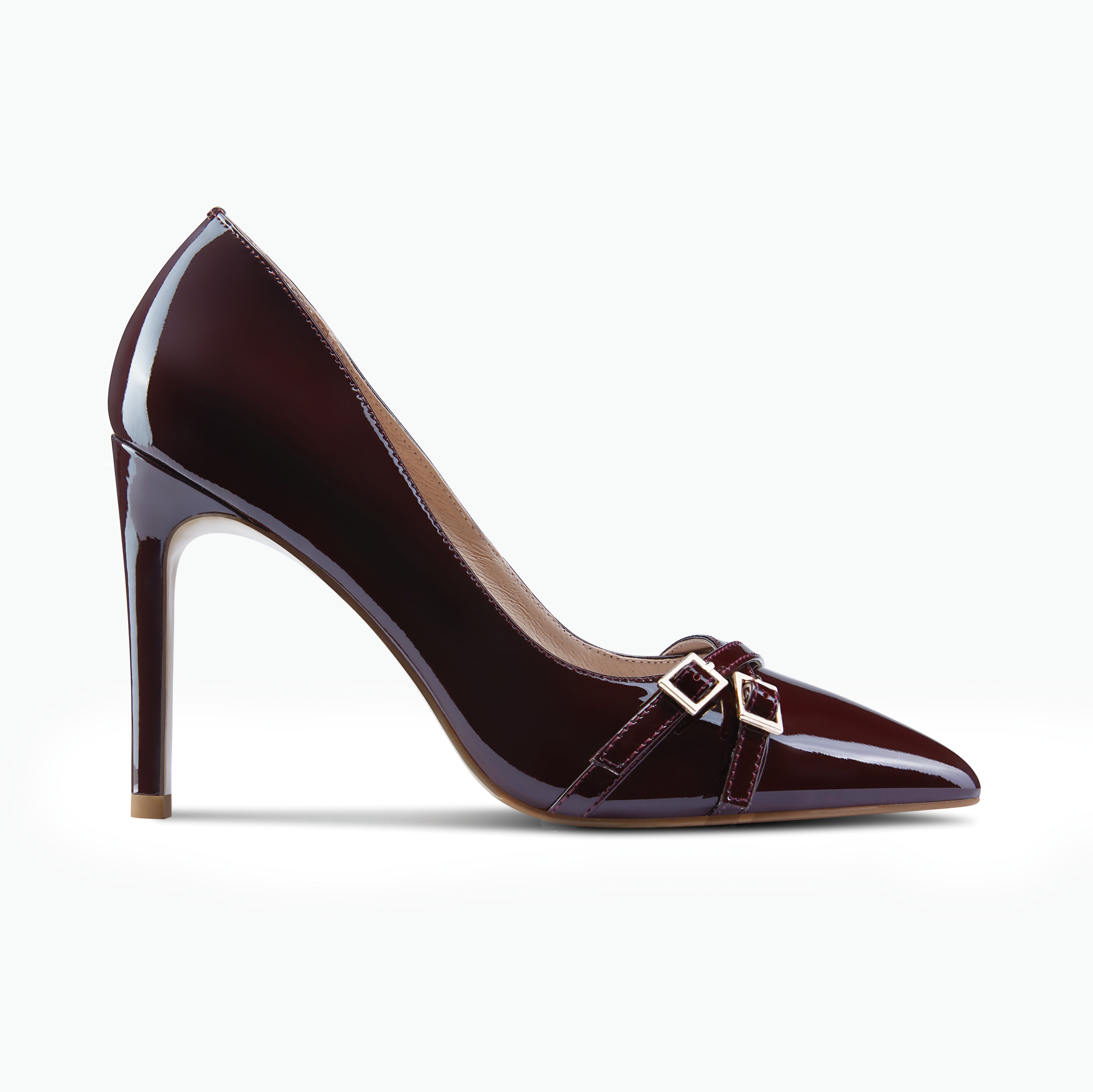 Nash pinot noir patent pump with straps and gold buckles shown from the side.