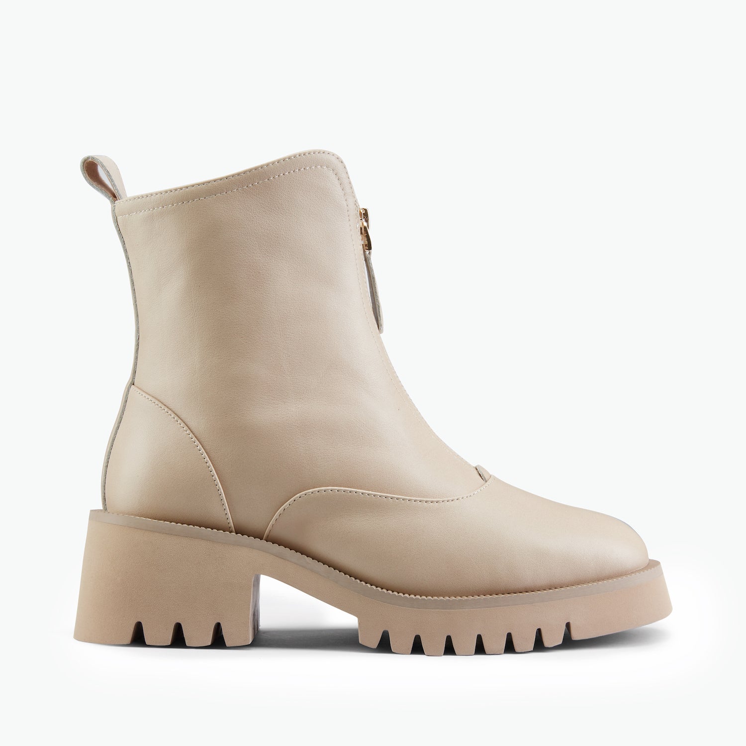 Beige combat ankle boots with front zip on white background.