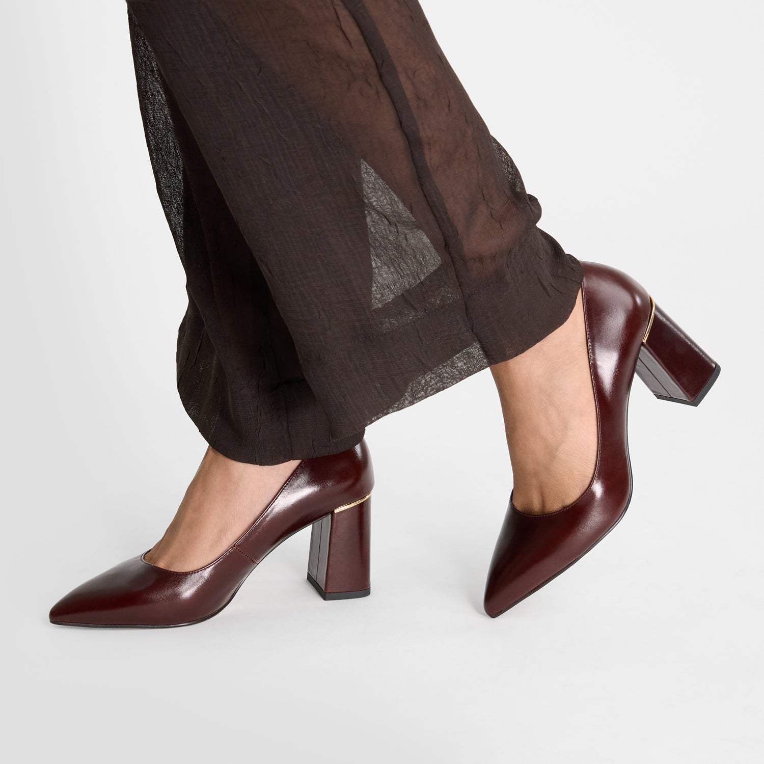 Brown high-heeled shoes worn by model. Pointed toe. 7.5cm heel by Nicole Rebstock.