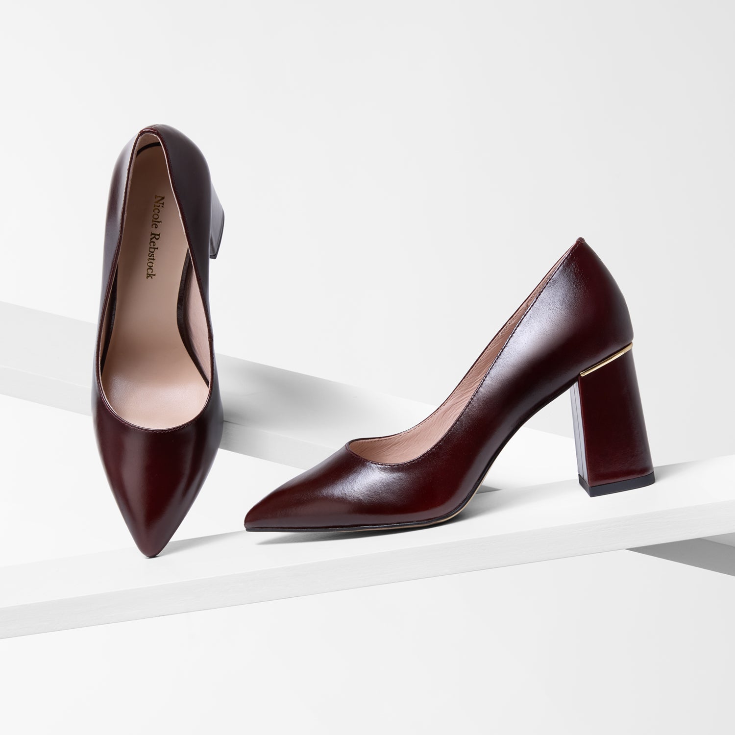 Pair of brown high-heeled shoes on a white background