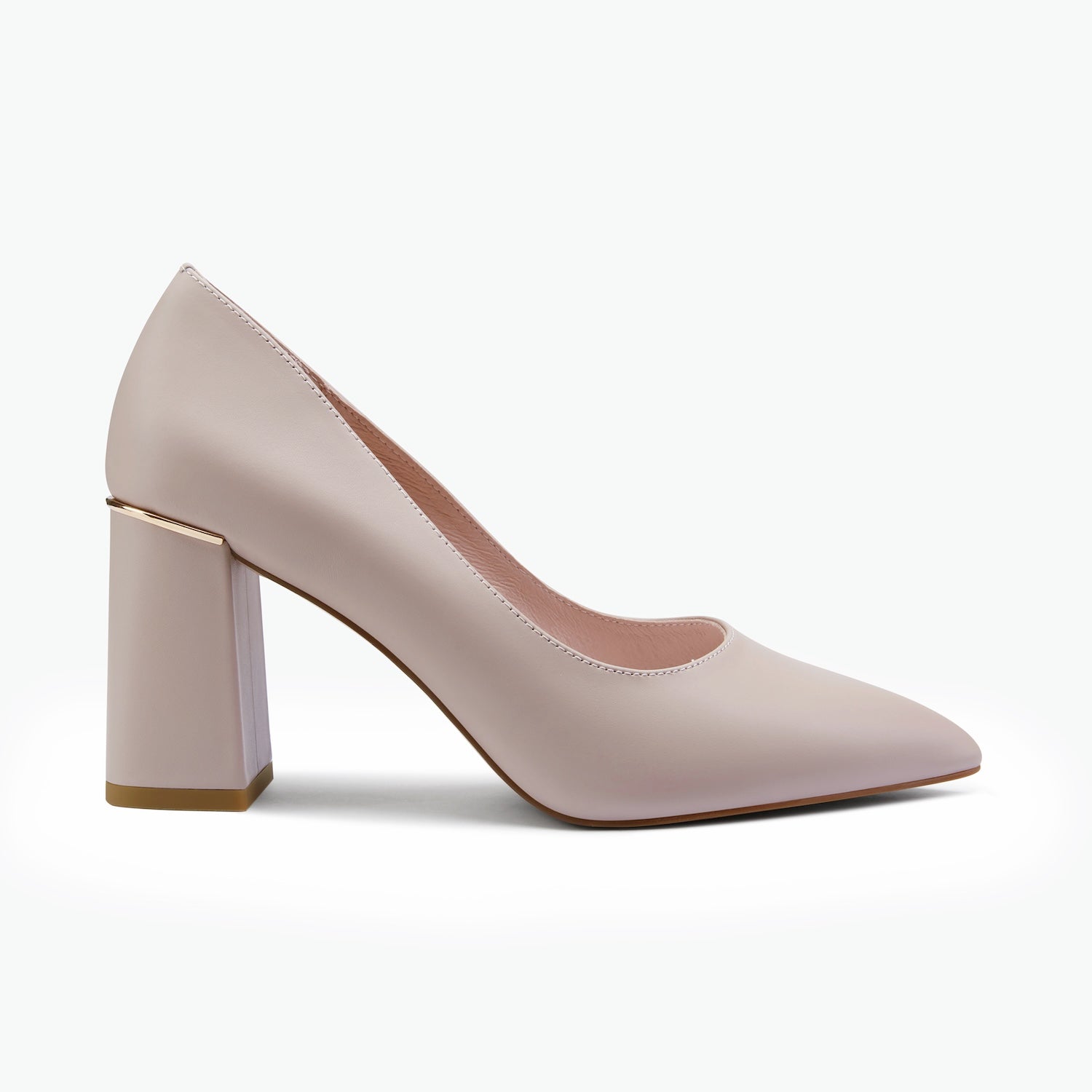 A single women's pump shoe in a pale blush color, featuring a pointed toe and a chunky block heel with a gold accent band, shown against a plain white background.