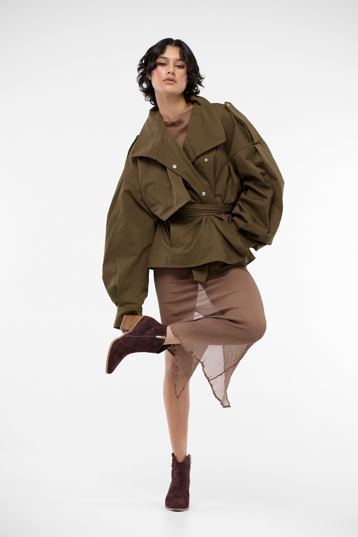 Model wearing brown suede cowboy boots.