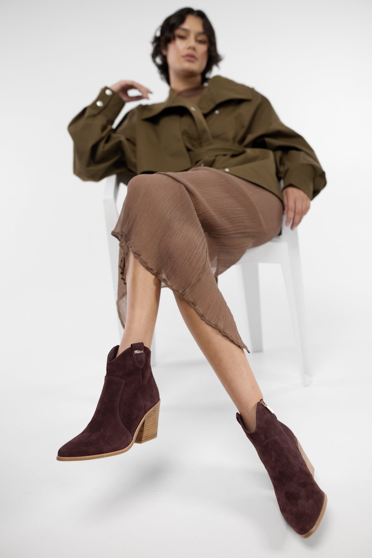 Nicole Rebstock's Franco Boots in chocolate brown suede with almond toe and gold accents worn by model.