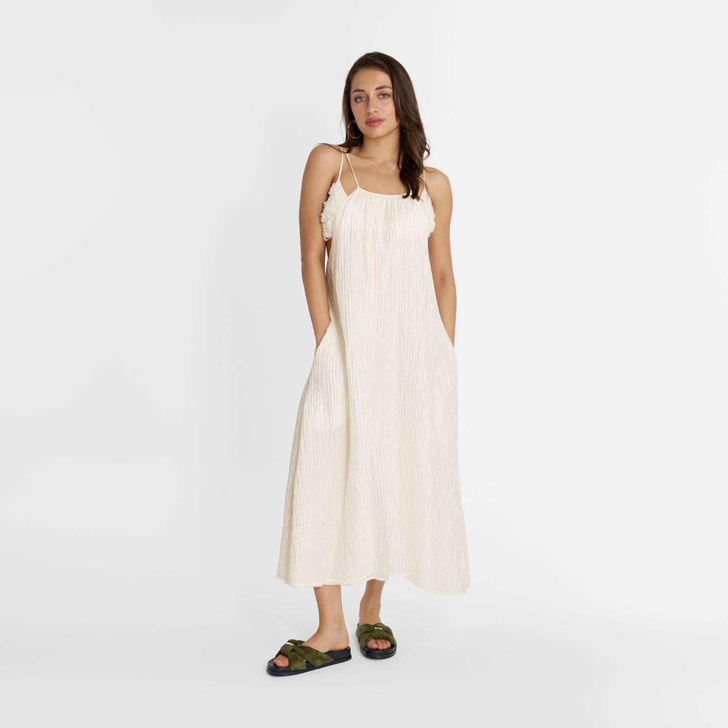 Women wears Nicole Rebstock olive green slides with gold detail on top