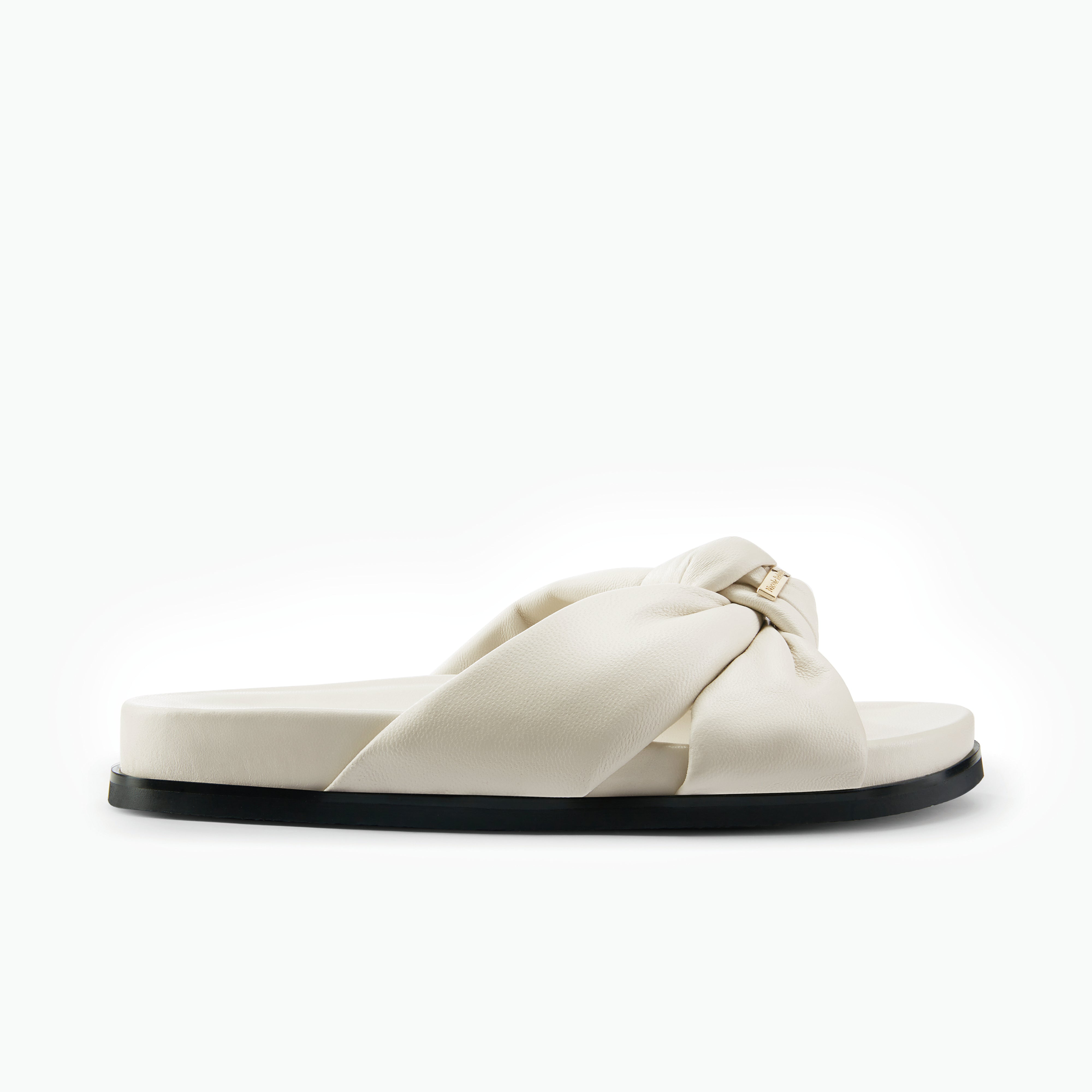 White sandal with a knotted design on a white background