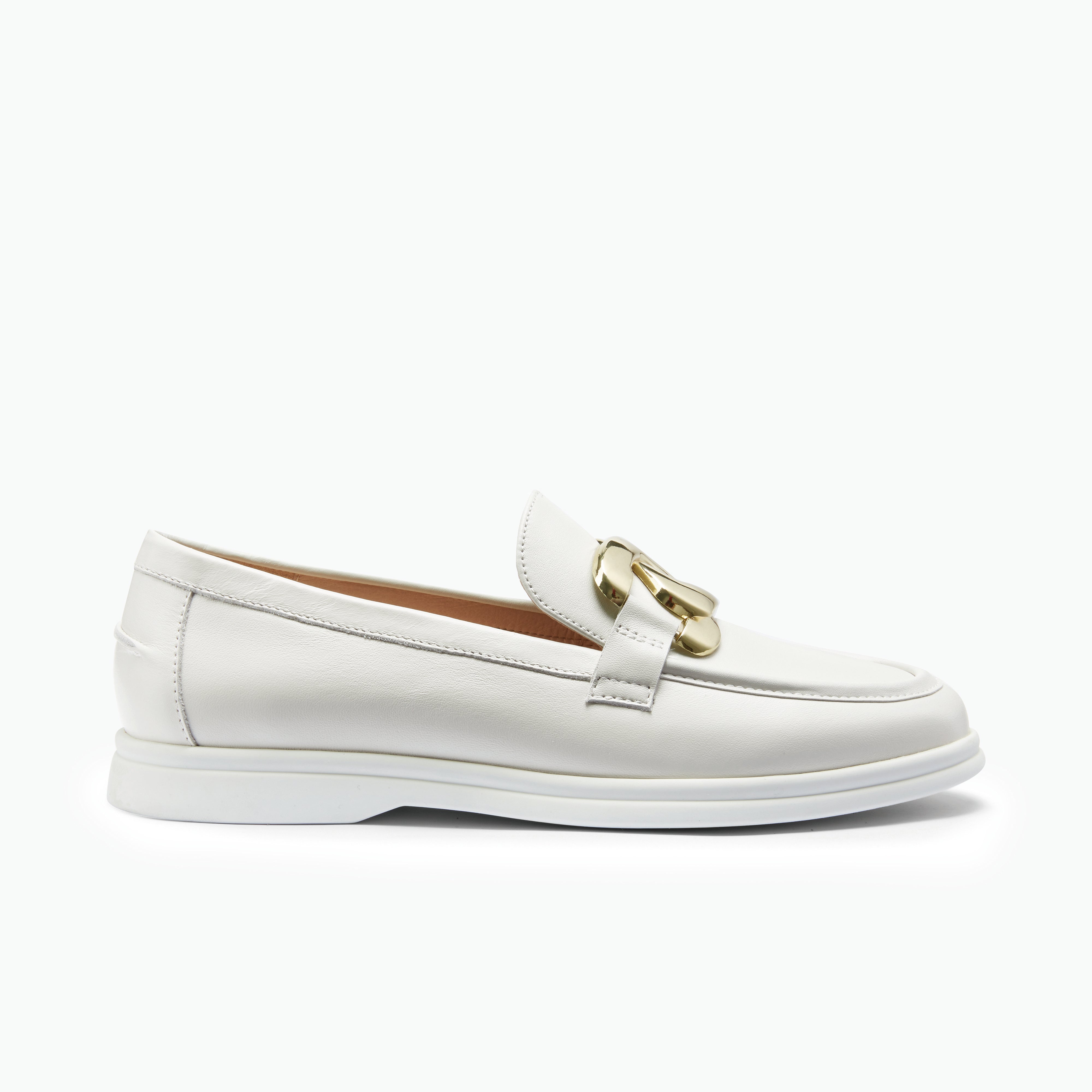 White loafer with gold buckle on a white background