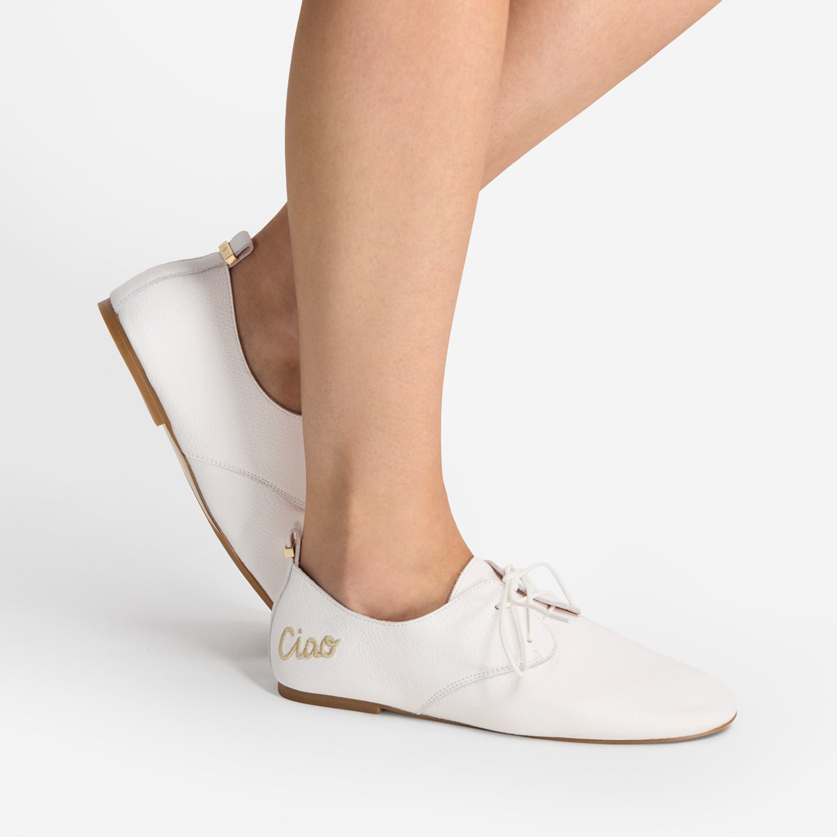 Close up of model wearing Nicole Rebstock's Xenia Flat in white