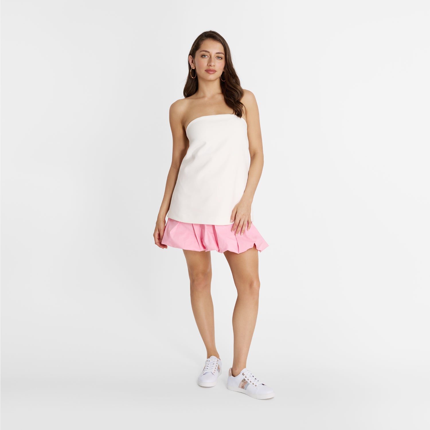 Woman wearing Nicole Rebstock Gigi Sneakers in white with rose gold accents. Comfortable.