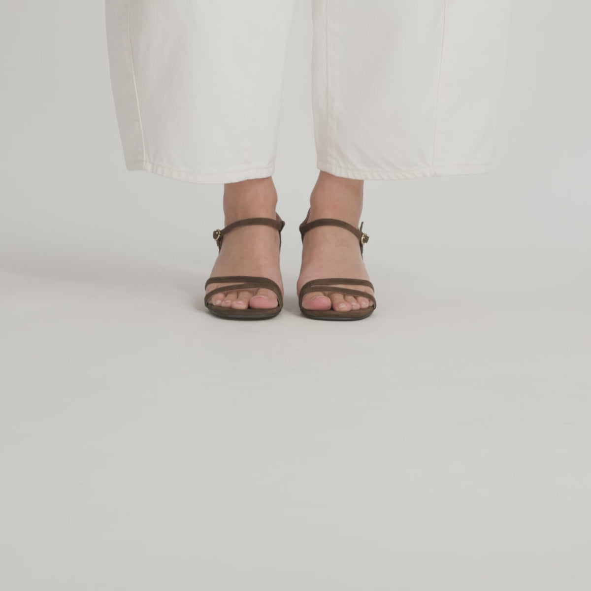 A video of a model wearing Nicole Rebstock's Marnie Sandal from each angle.
