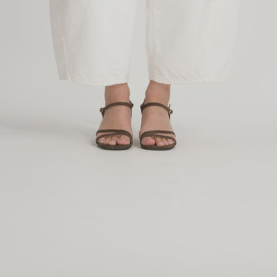 A video of a model wearing Nicole Rebstock's Marnie Sandal from each angle.
