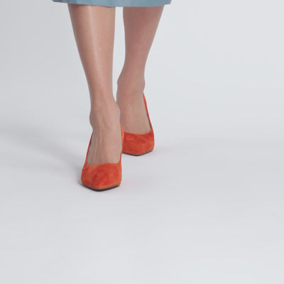 Model wearing orange stilettos by Nicole Rebstock