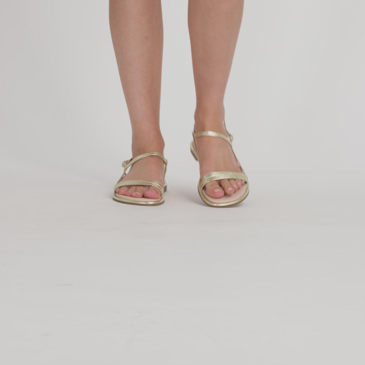 Video of model showing Nicole Rebstock's gold Louis Sandals from all angles.